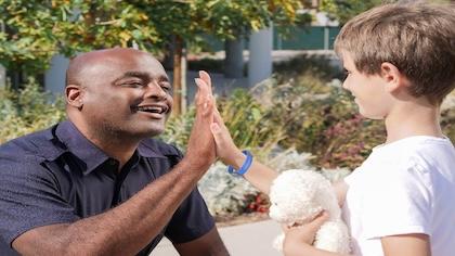 Child and officer with a wristband on the child's wrist.